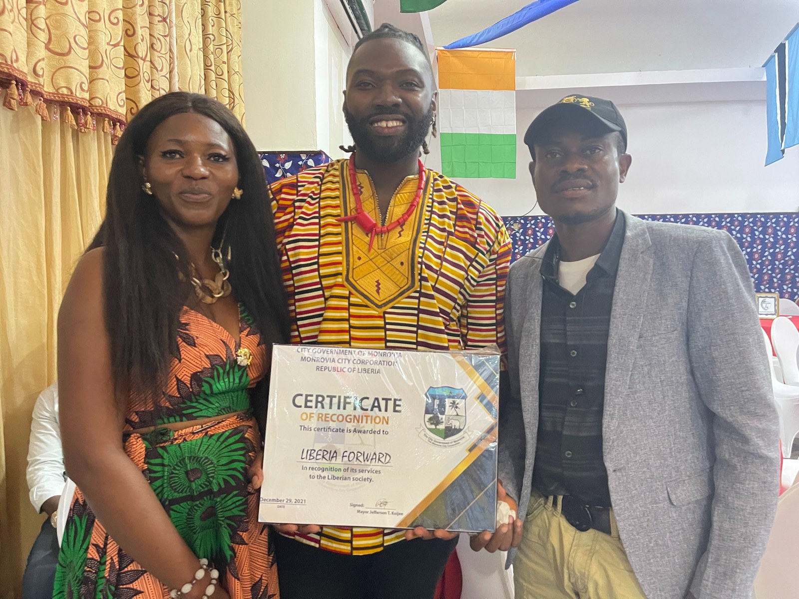 Lawrence and the Liberia Forward team holding the Certificate of Recognition