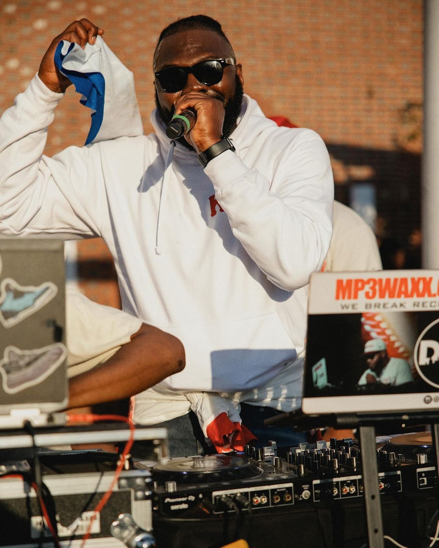 Lawrence on the mic at an outdoor event